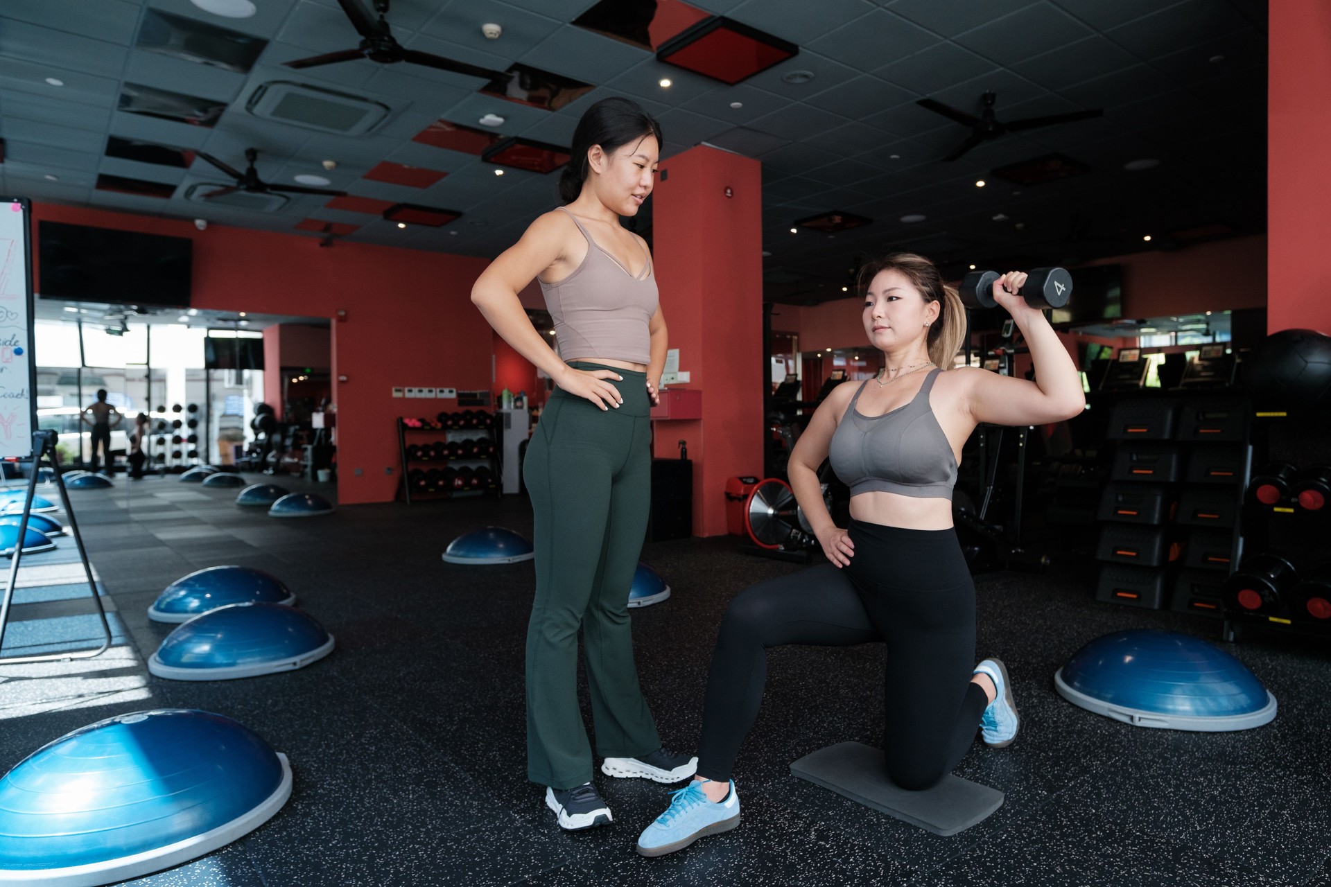 Two Asian Women in Personal Training Session at Gym