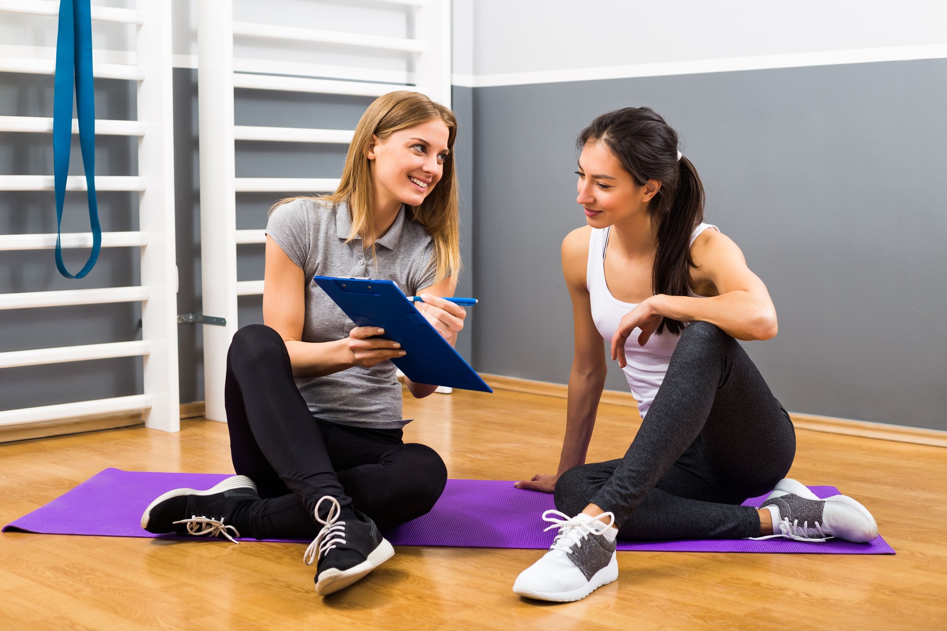 Woman and her personal trainer talking